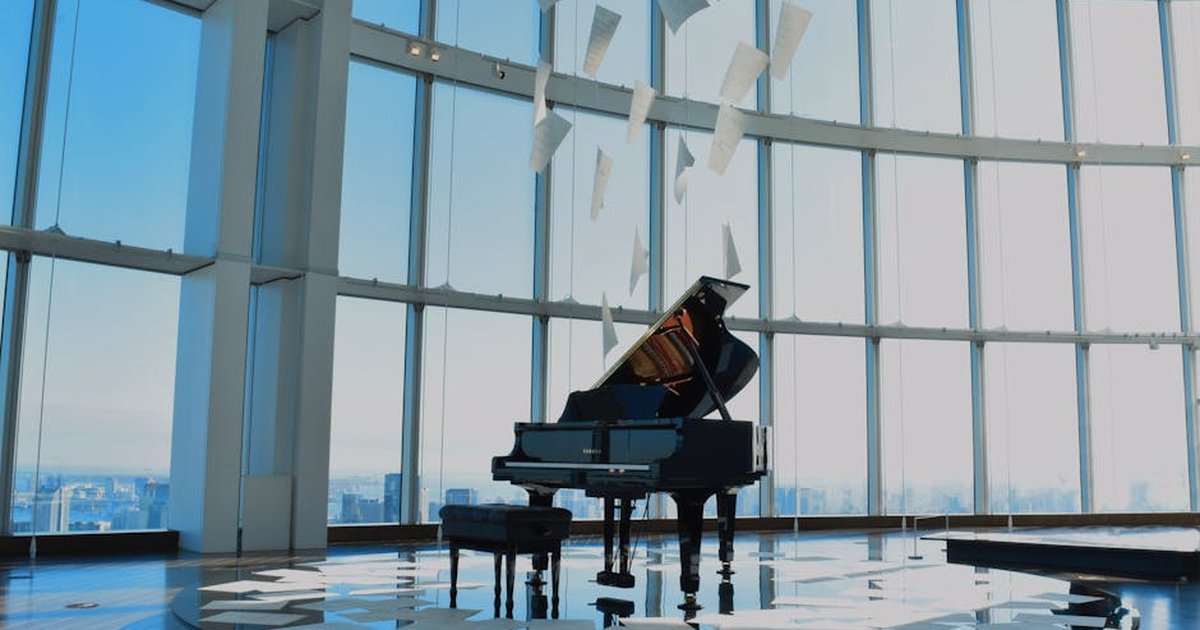 Grand piano in a glass atrium with floating sheets of music, creating a serene ambiance.