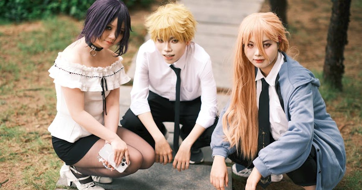 Vibrant cosplay group posing outdoors, showcasing detailed costumes with unique hairstyles.