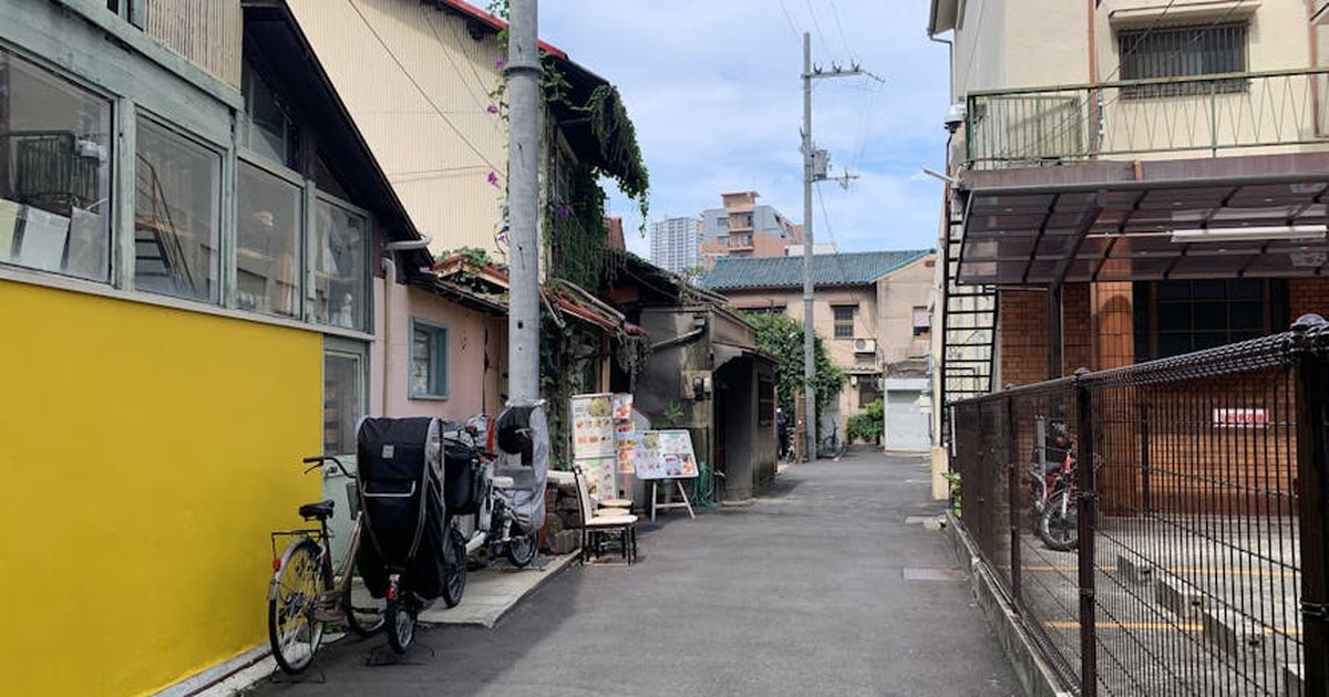 Charming street scene in Osaka with bicycles and quaint architecture.