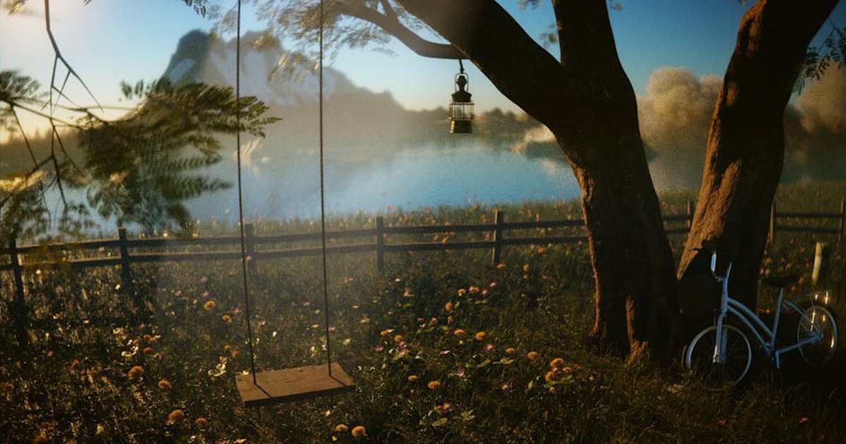A tranquil lakeside scene with a swing, bicycle, and lantern under a tree during sunset.