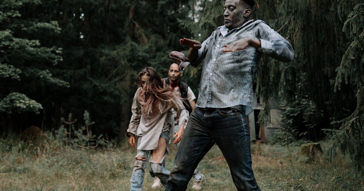 Terrifying zombies stumbling through a dark, creepy forest setting, perfect for horror themes.
