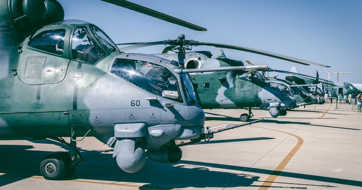 Line of military helicopters on an airfield under clear blue skies in Brasília, Brazil.
