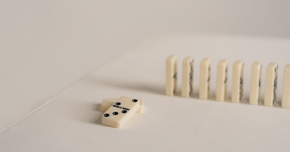 Close-up of domino tiles arranged in a row, highlighting minimalistic game setup.
