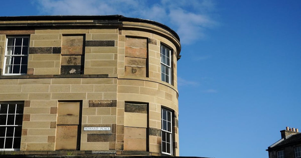 Stone facade of Howard Place in Edinburgh, captured under a clear blue sky.