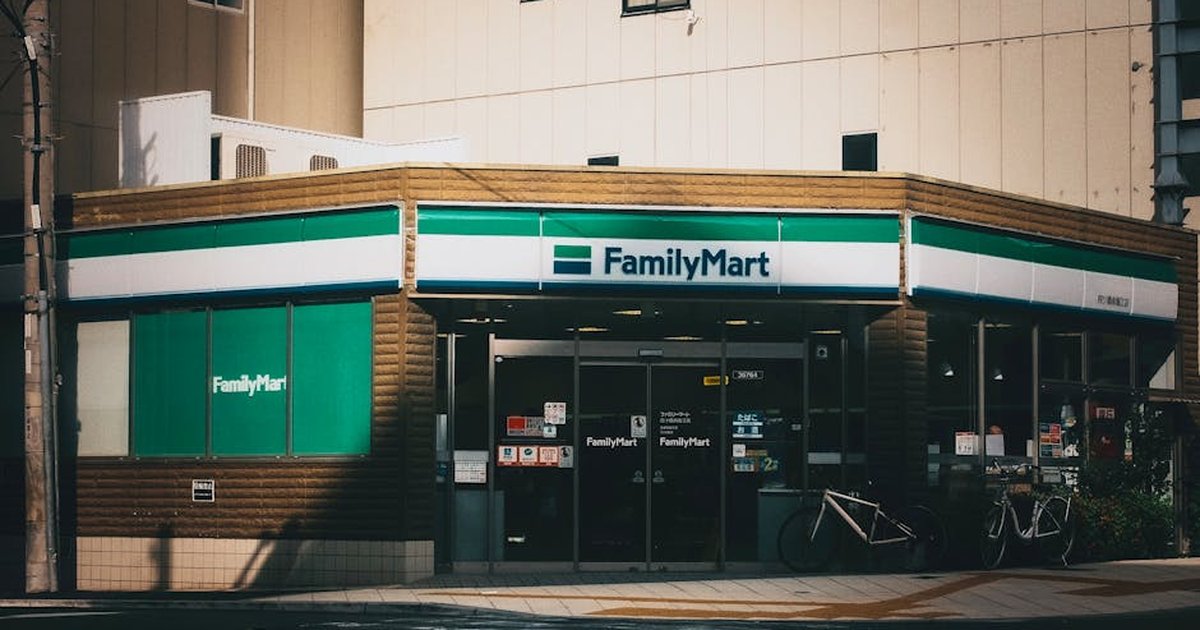 Outdoor view of a FamilyMart convenience store with bicycles parked outside.