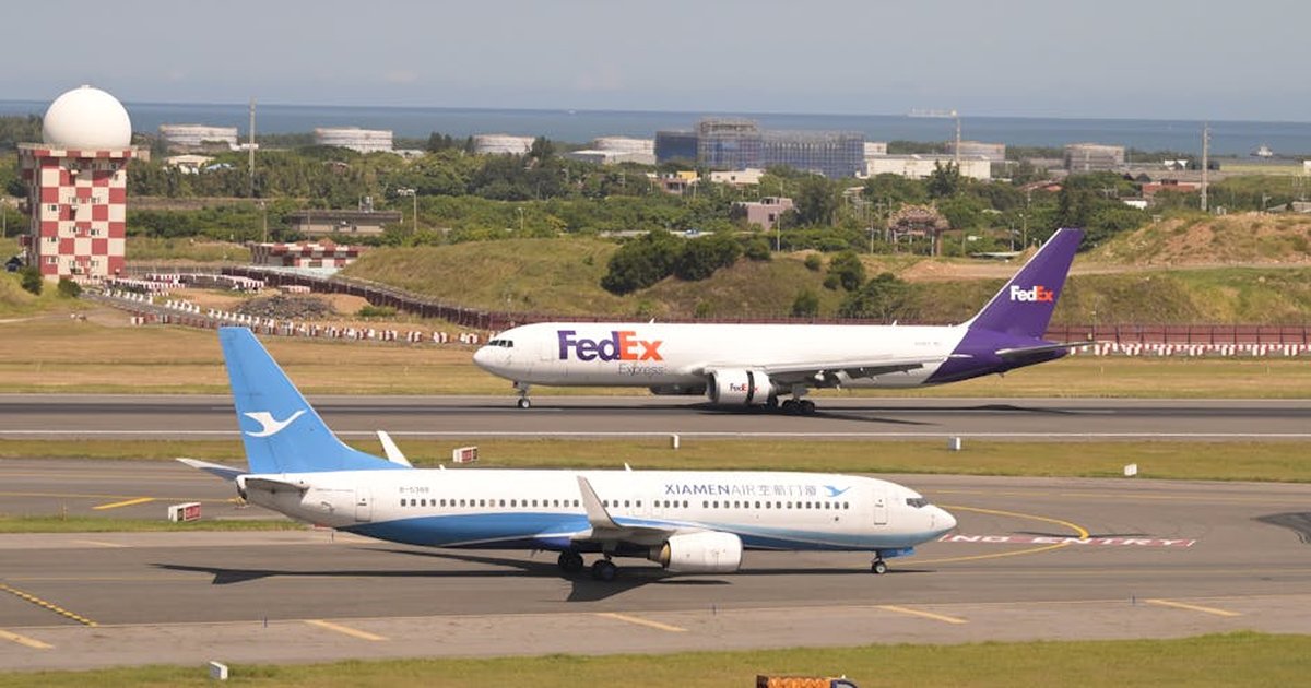FedEx and Xiamen Air planes on runway at Taoyuan International Airport in Taiwan.