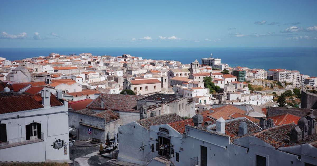 Picturesque view of Monte Sant'Angelo in Apulia, Italy with the sea in the background.