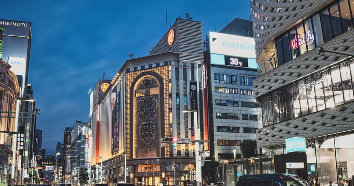 A bustling evening view of the famous Ginza district in Tokyo, showcasing vibrant city life and architecture.