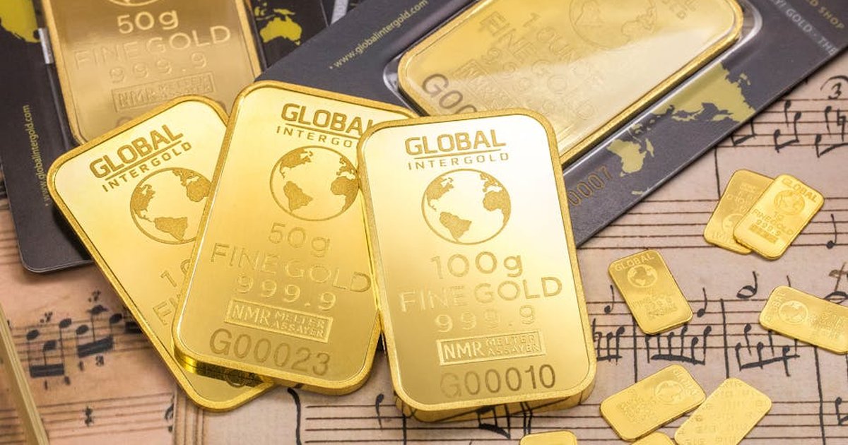 Gold bars stacked on sheet music, showcasing wealth and luxury with fine detail.