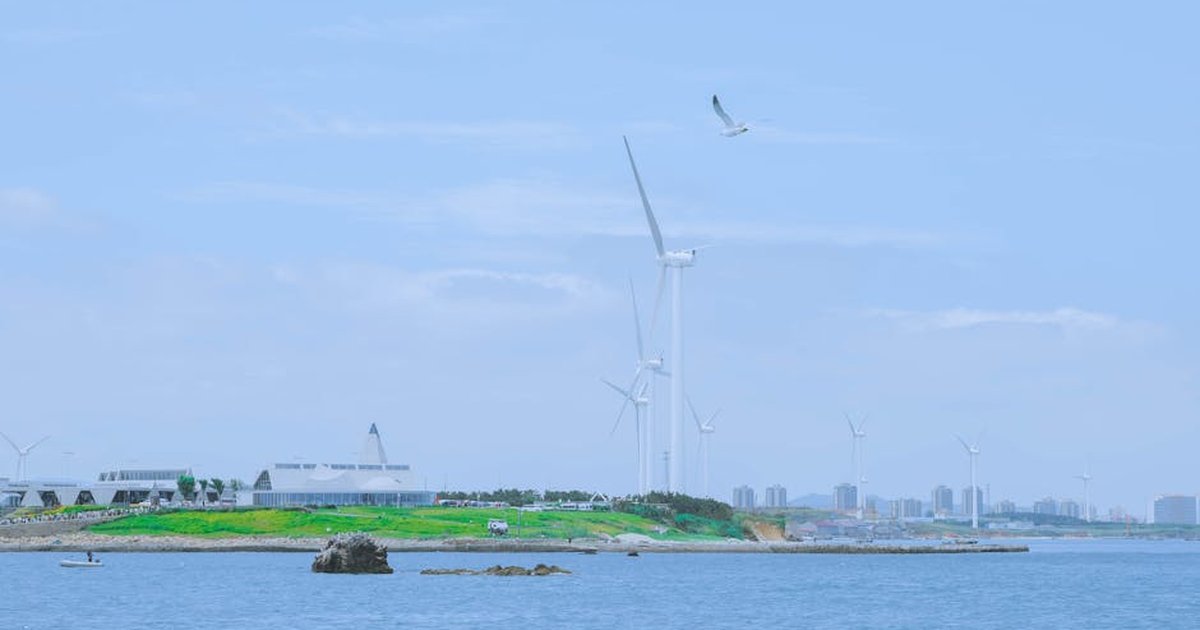 Scenic view of wind turbines on the seashore in Weihai, Shandong, China, highlighting renewable energy.