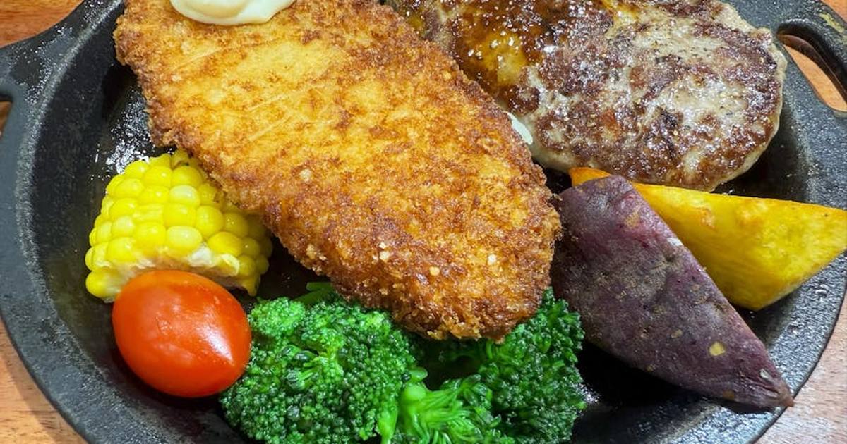 A mouth-watering assortment of grilled meats and vegetables served on a cast iron skillet.