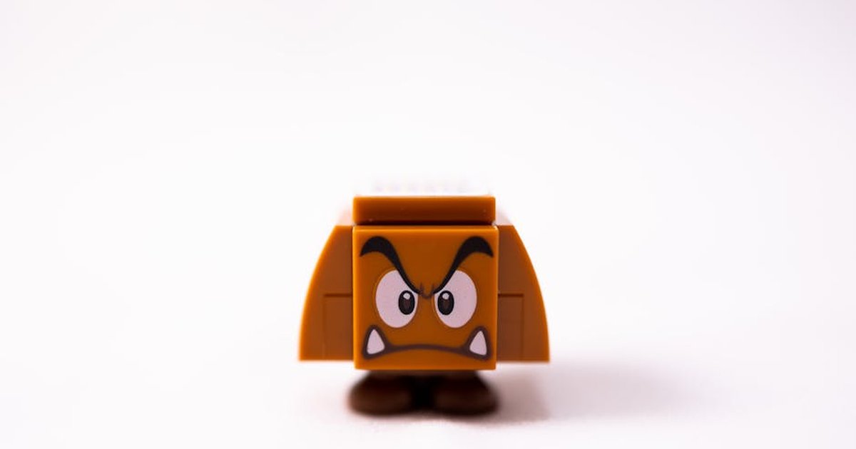 Small brow toy of evil mushroom made of plastic details against white background