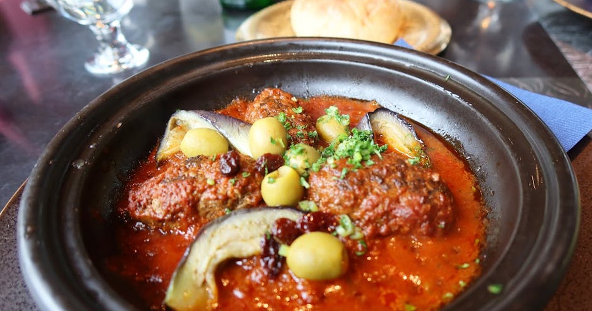 A savory Moroccan lamb tagine with olives and eggplant, perfect for a gourmet dining experience.