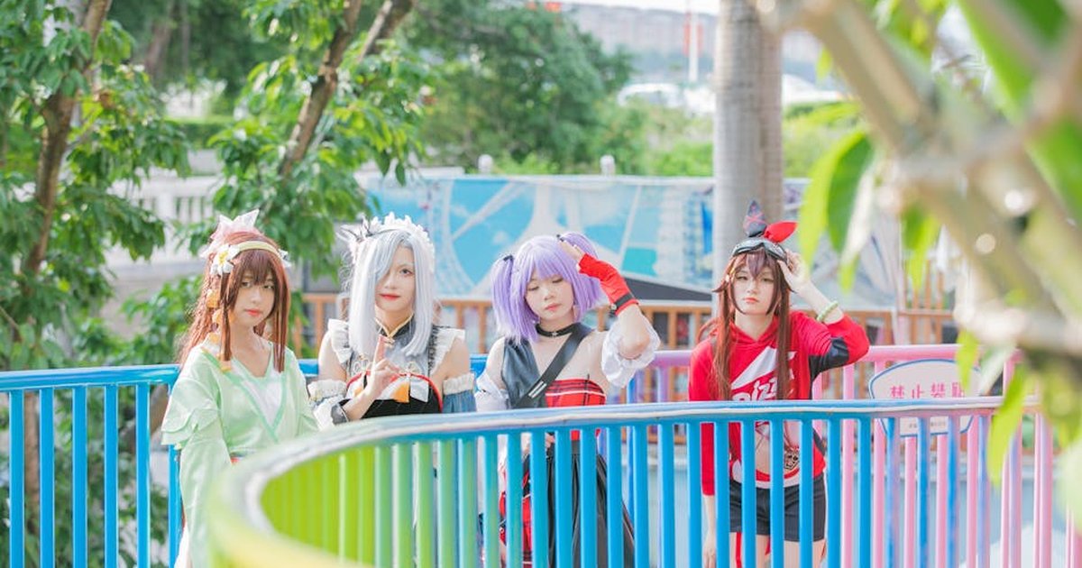Vibrant cosplay group enjoying a sunny day at an amusement park.