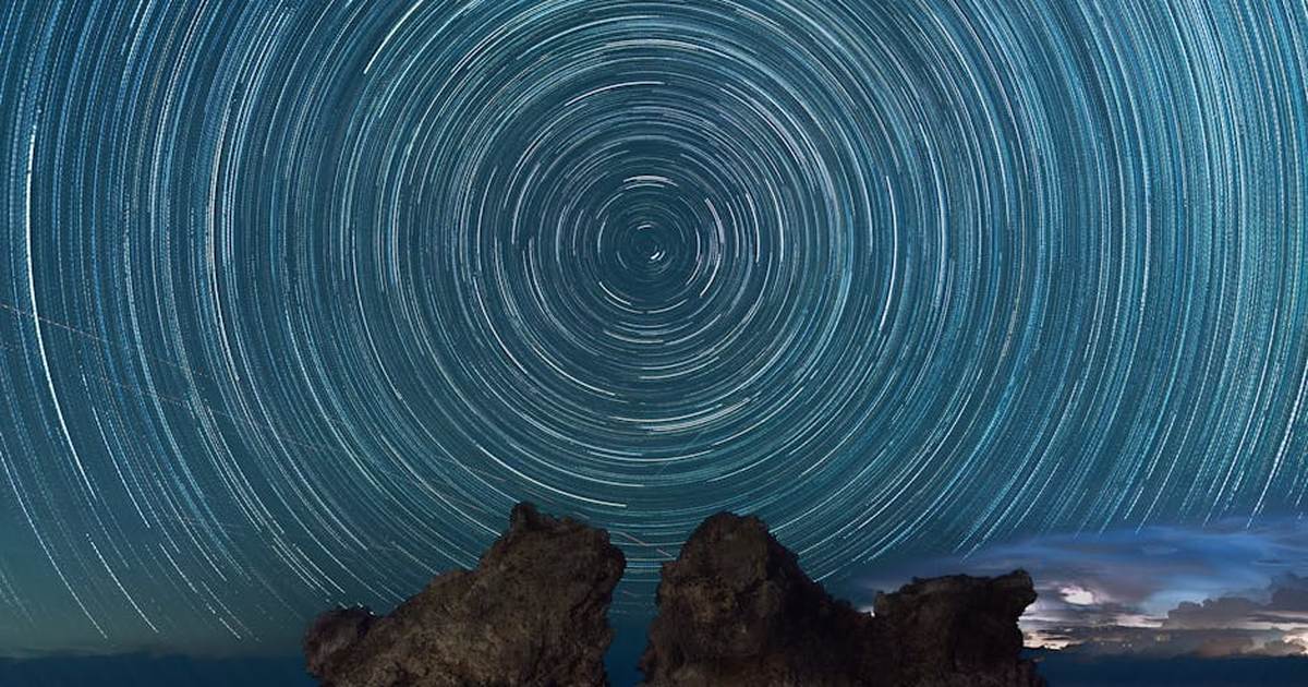 Stunning night sky star trails over a rock formation on Lanyu Island, Taiwan.