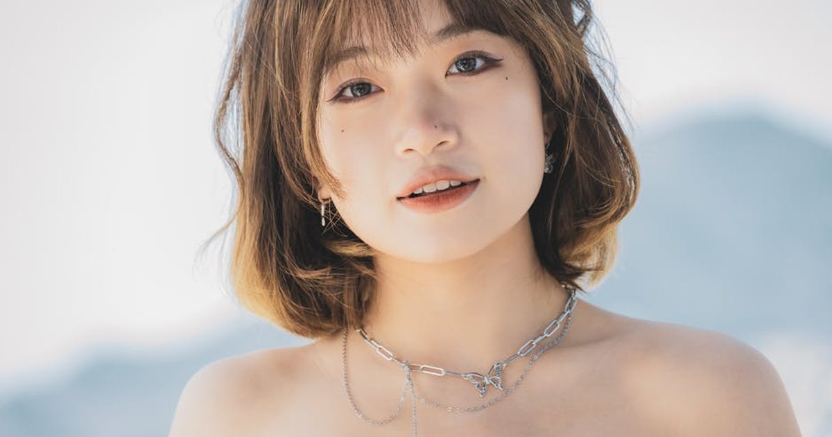 Close-up portrait of a stylish woman with necklace, outdoors in Montenegro.
