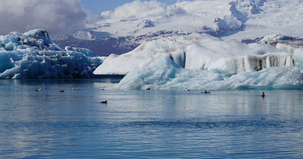 Stunning view of icebergs and serene water in an Icelandic glacier lagoon.