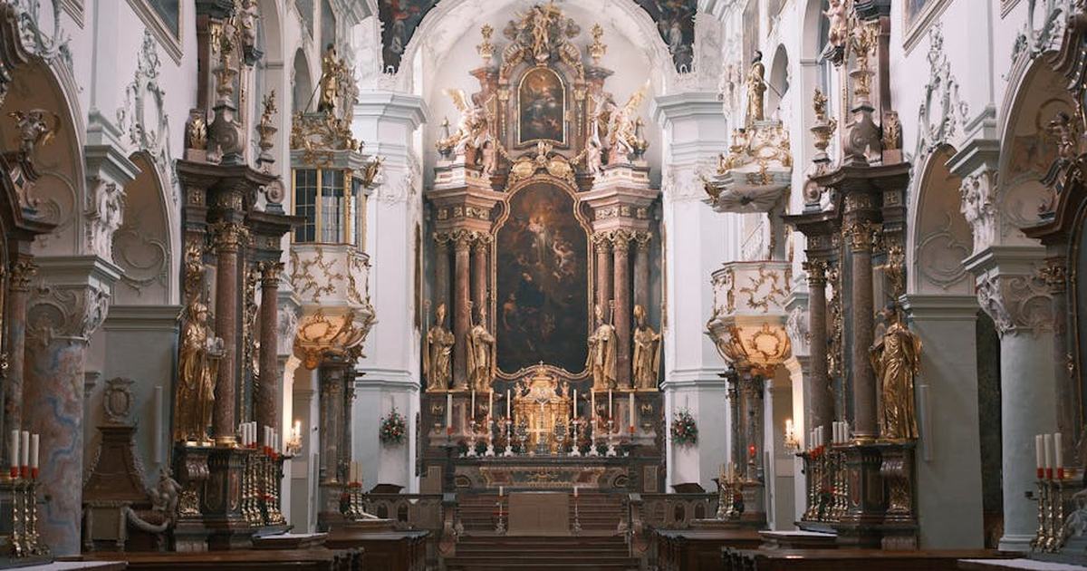 Stunning baroque church interior in Vienna, showcasing ornate altar and sculptures.
