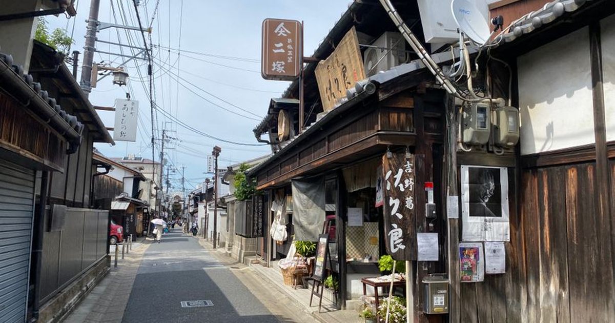 Scenic view of a narrow street in Ikaruga, Nara, Japan with traditional wooden houses and shops.