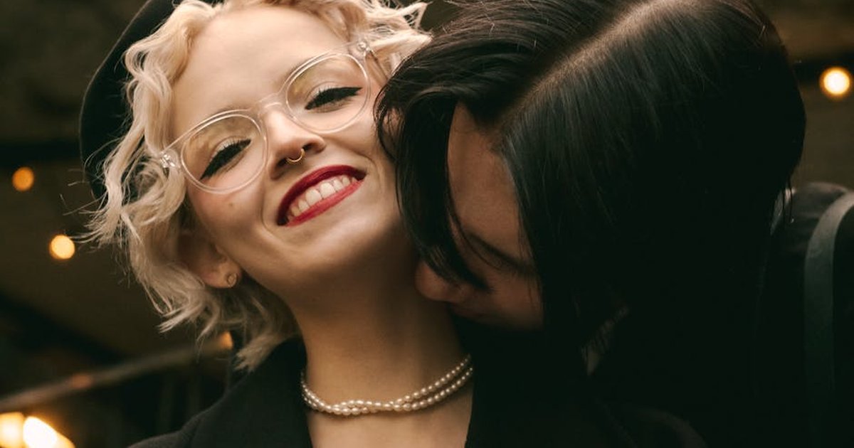 A joyful couple shares a loving embrace outdoors, highlighting happiness and affection.