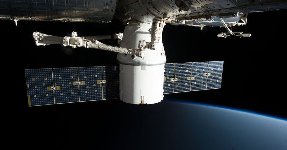Image of the International Space Station floating above Earth with visible solar panels.