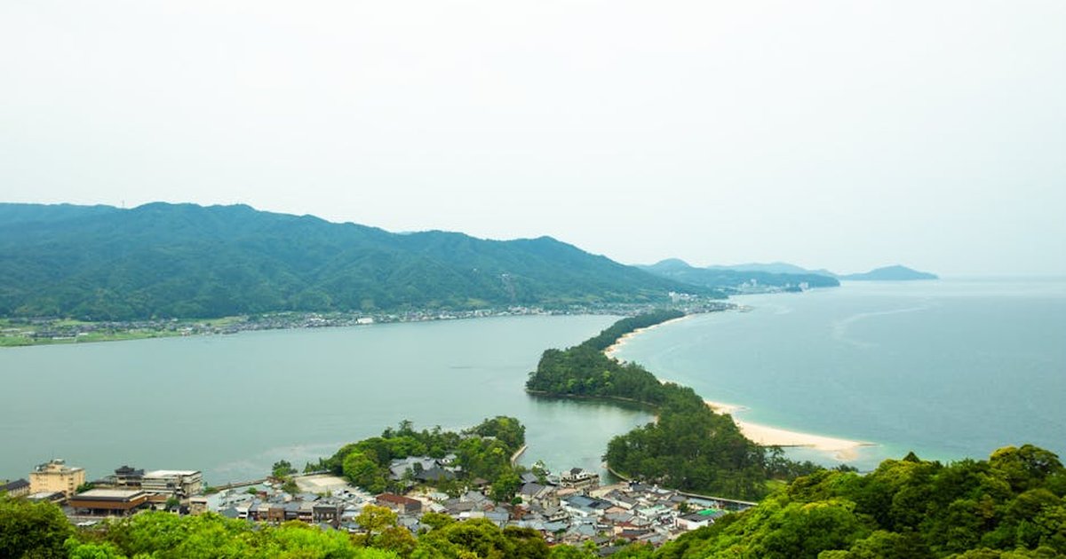 Amazing scenery of Amanohashidate sandbar covered with pine trees and connecting Miyazu Bay surrounded by green hills