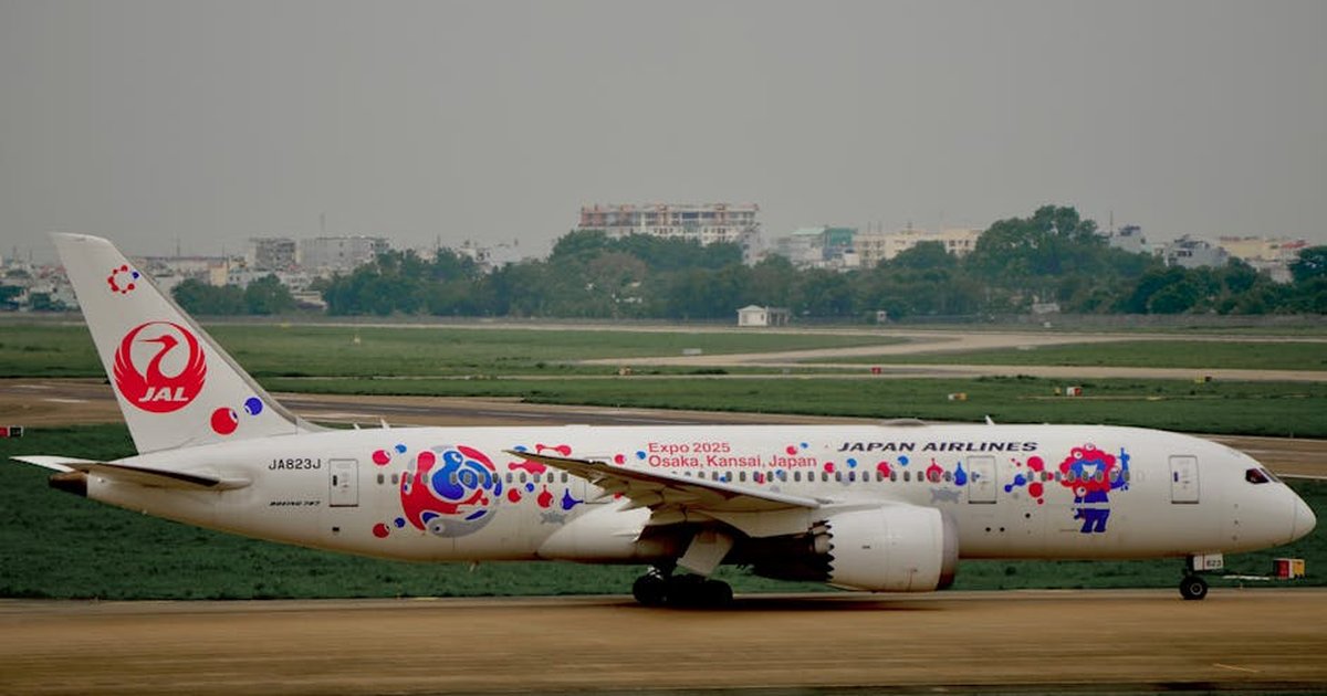 Japan Airlines aircraft taxiing with Expo 2025 Osaka Kansai design at airport.