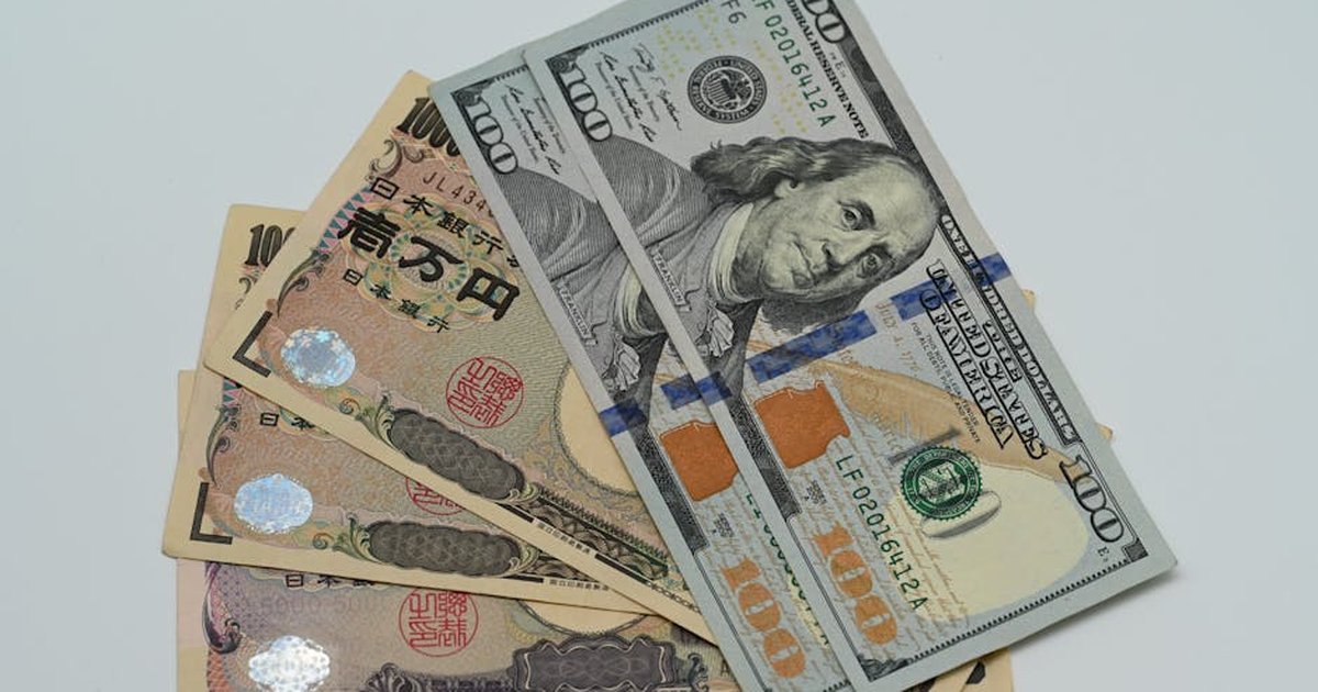 Close-up image of US dollars and Japanese yen notes, representing currency exchange concept.