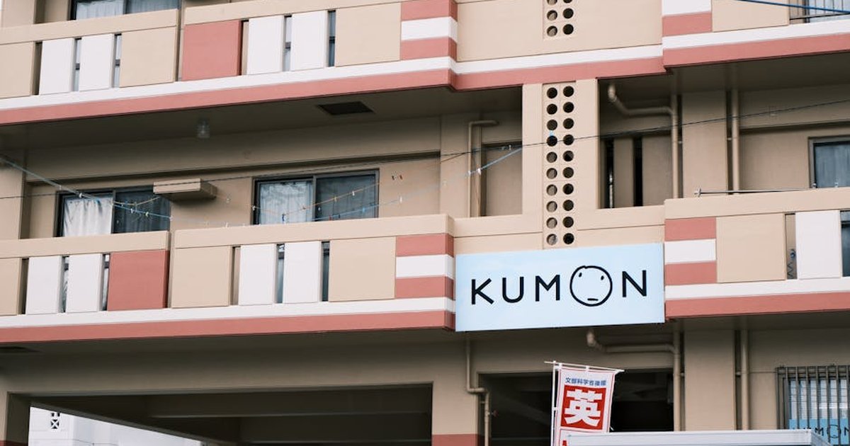 Residential building in Tokyo, Japan, featuring Kumon sign and urban architecture.