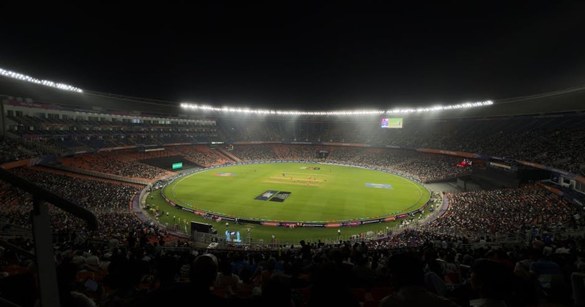 A captivating night cricket match with a large crowd at Narendra Modi Stadium in Ahmedabad, India.