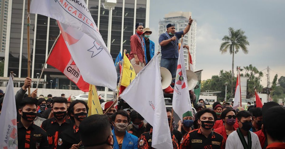 Crowd of activists protesting with banners in Jakarta, Indonesia.