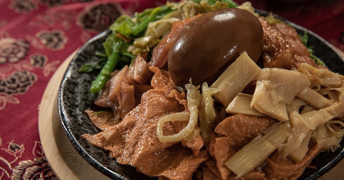 A savory dish featuring traditional Taiwanese street food with a marinated egg and vegetables, perfect for food enthusiasts.