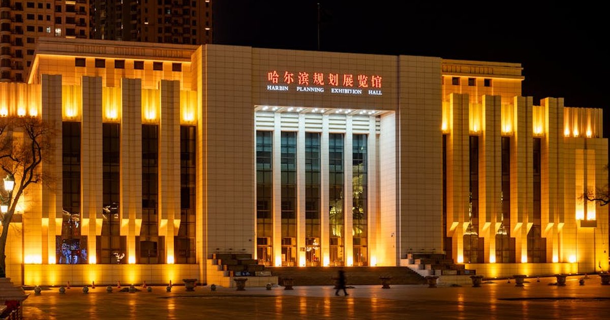 Illuminated Harbin Planning Exhibition Hall, a striking architectural landmark in Harbin, China.