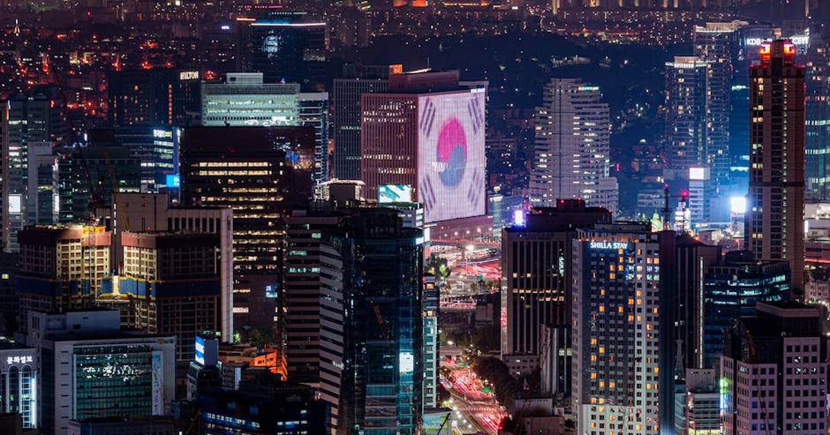 Vibrant night skyline of Seoul featuring illuminated skyscrapers and urban landscape.