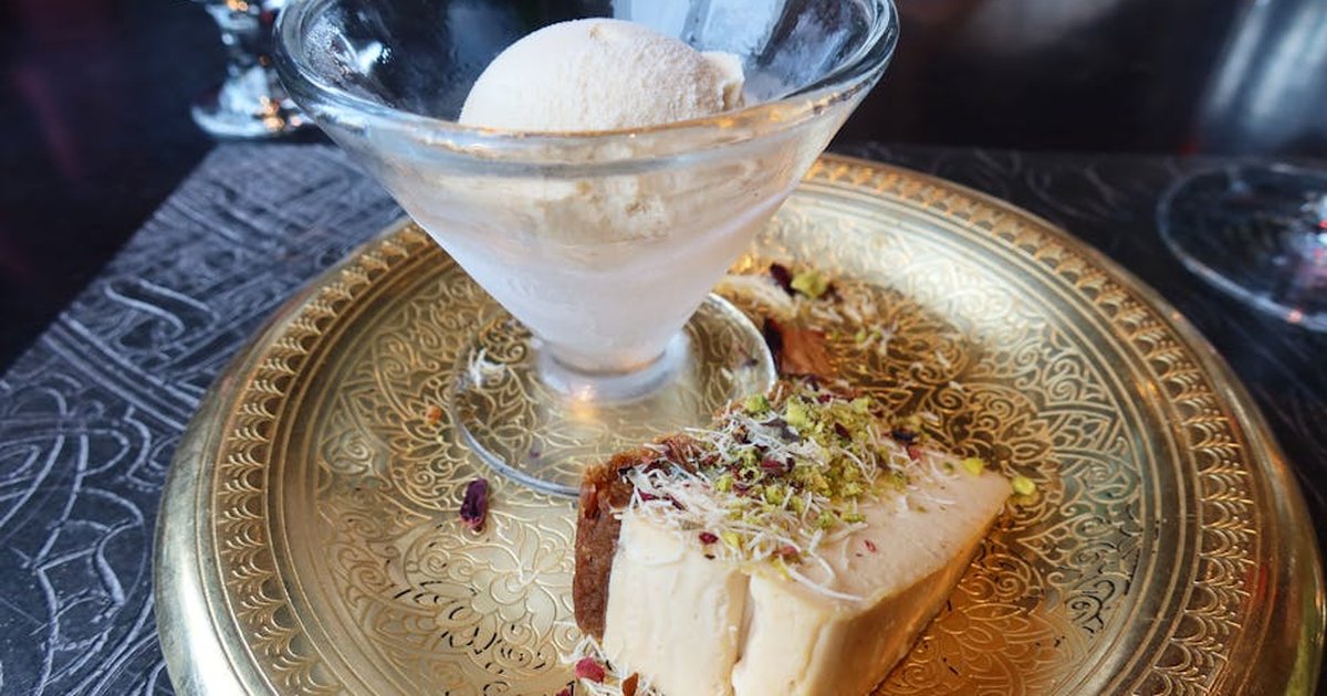 Exquisite dessert with ice cream and cake served on a decorative plate, perfect for elegant dining experiences.