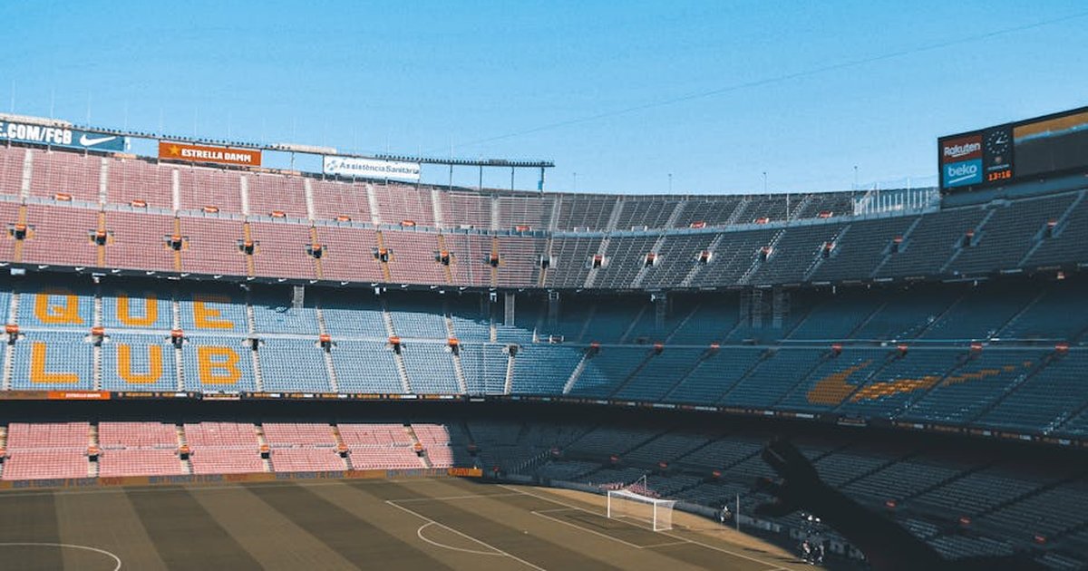 Wide shot of the iconic Camp Nou stadium in Barcelona, showcasing empty seats and football field.