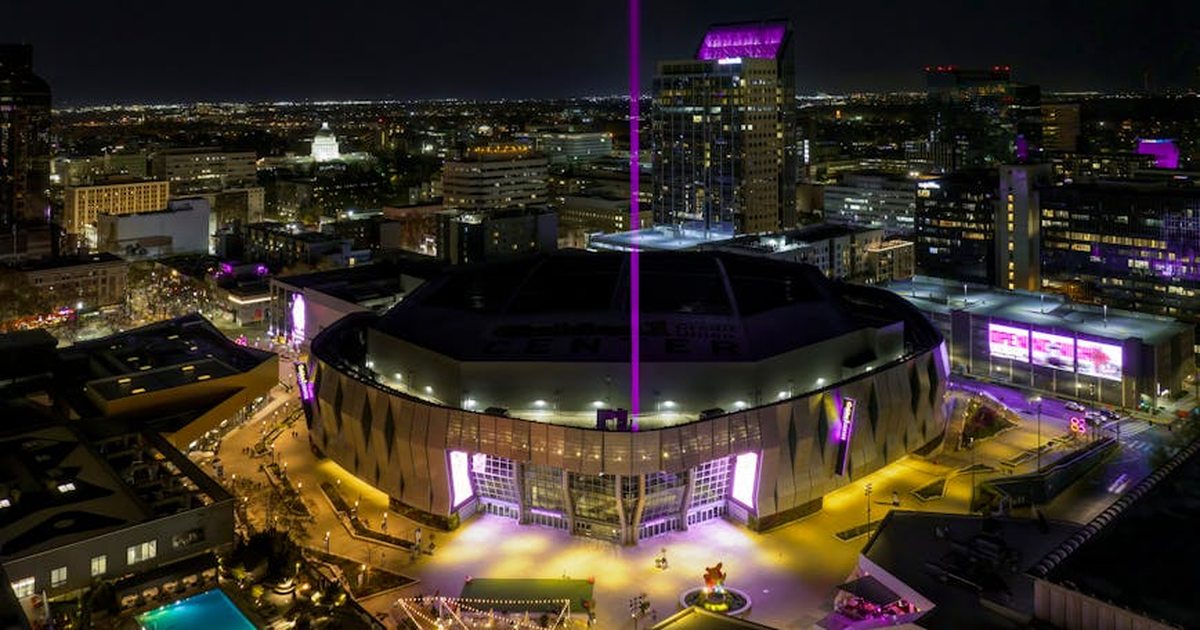A stunning aerial view of the illuminated Golden 1 Center in downtown Sacramento at night.