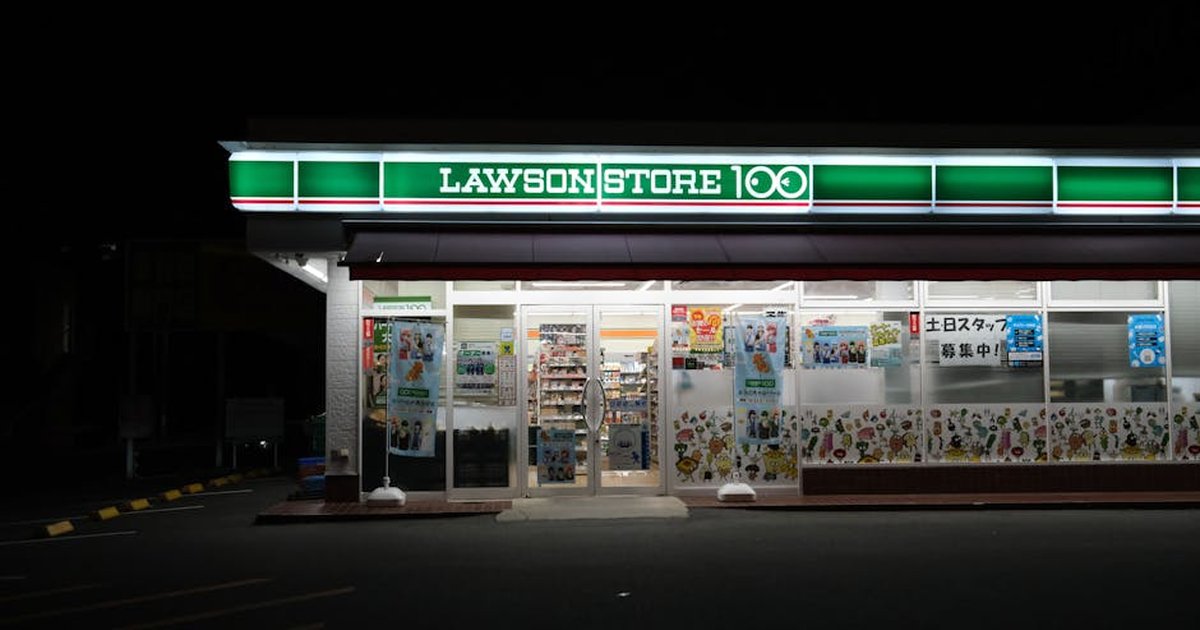 Exterior of Lawson Store 100 at night in Toyohashi, Aichi, Japan.