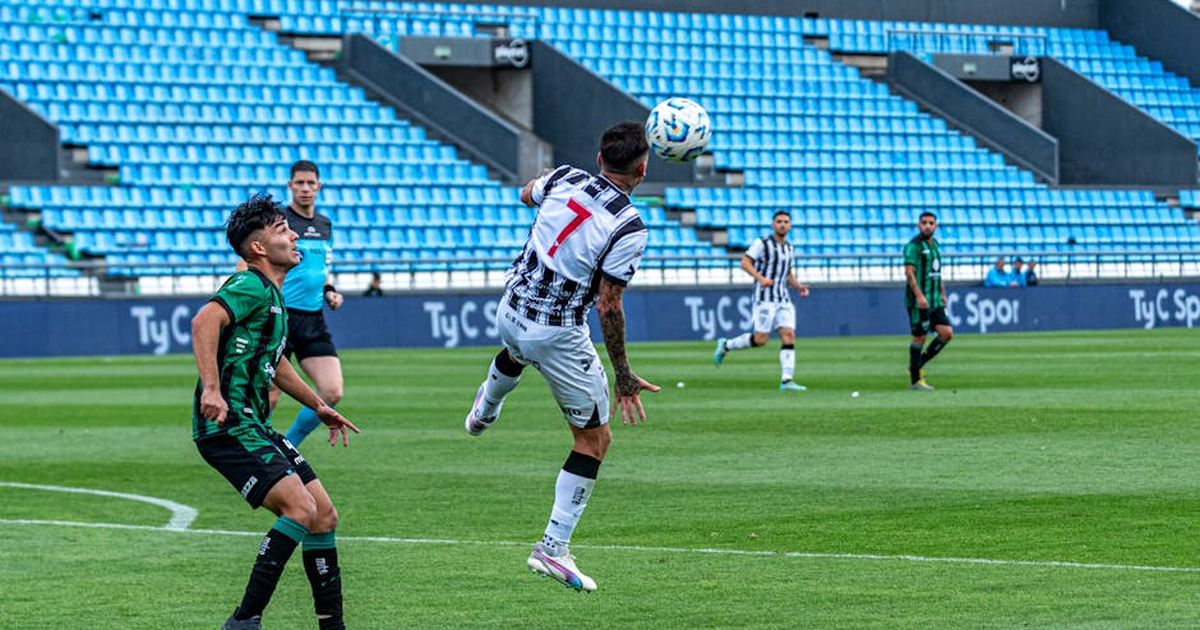 Action-packed soccer match with players competing in a vibrant stadium.