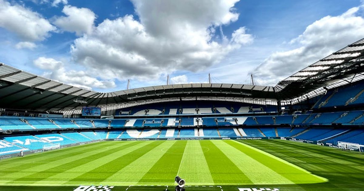 A view of the iconic Etihad Stadium in Manchester, United Kingdom, showcasing its vibrant football field.