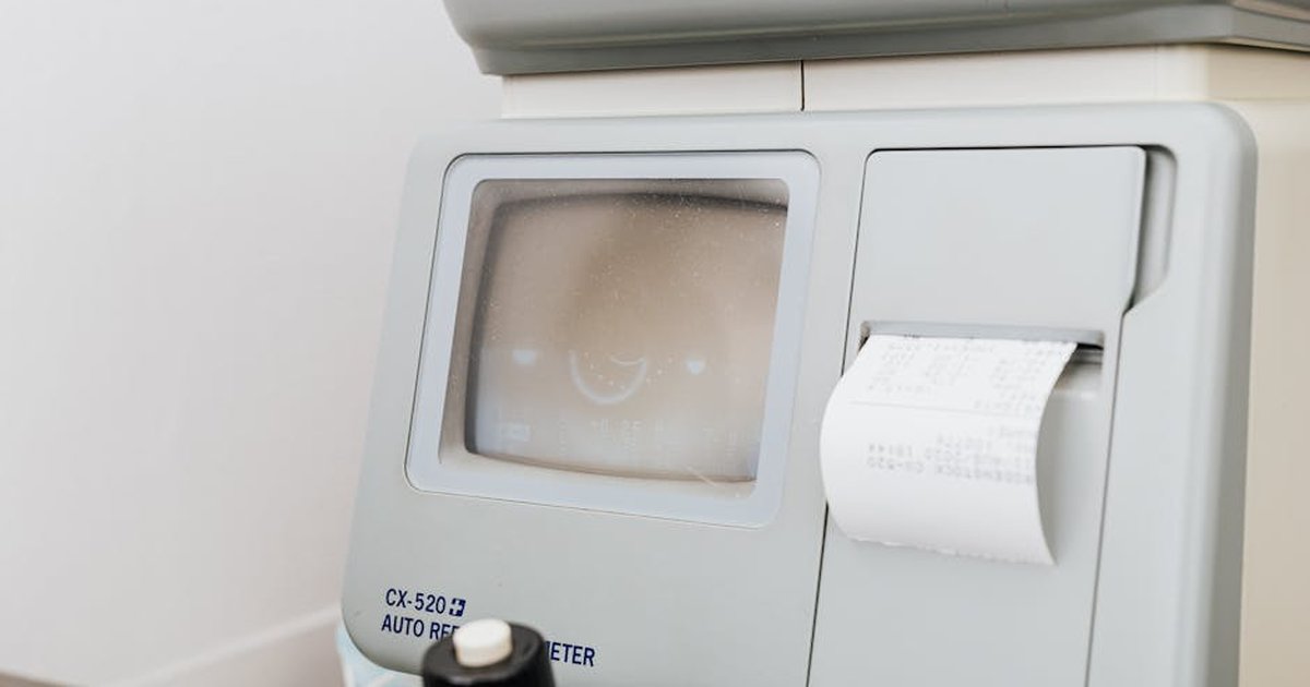 Close-up of optometry equipment showing printed receipt and display.