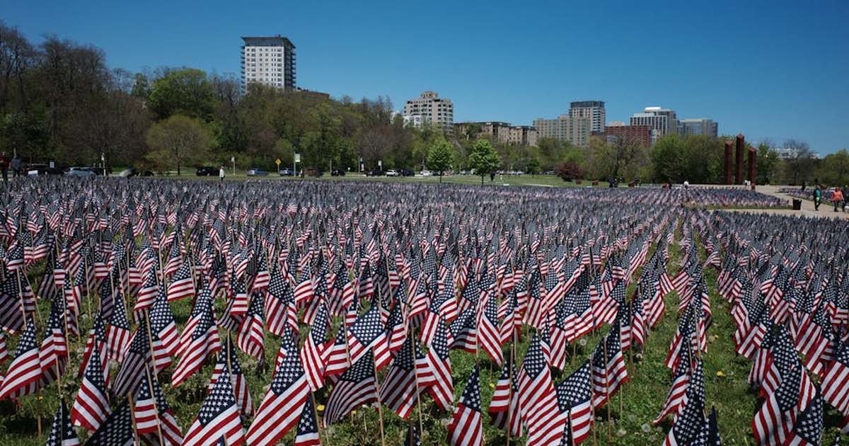 A vast field of American flags honors Memorial Day in a city park.