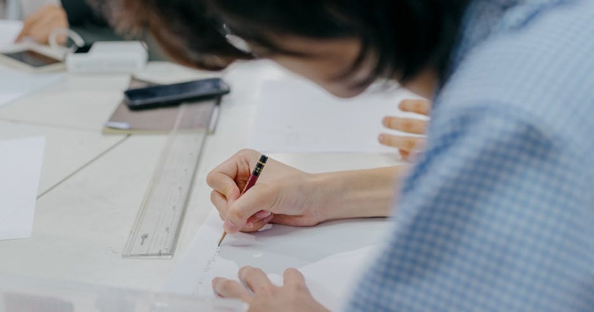 Close-up of students engaging in creative work during an art session in a Tokyo classroom.