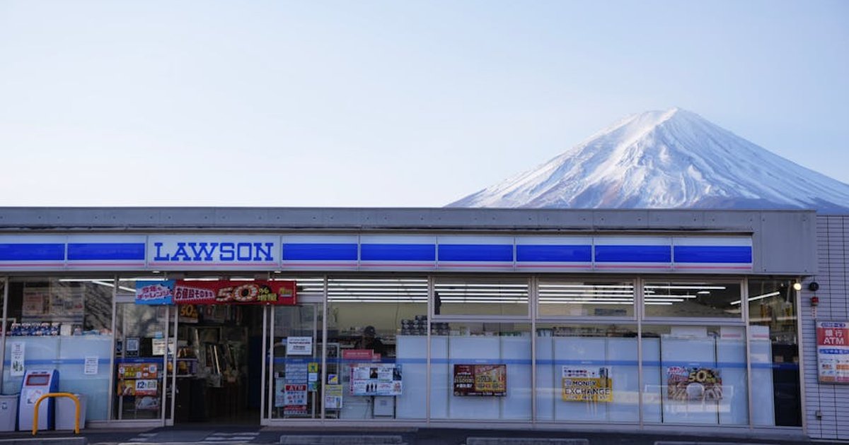 Lawson convenience store with Mount Fuji backdrop in Yamanashi, Japan, capturing serene rural lifestyle.