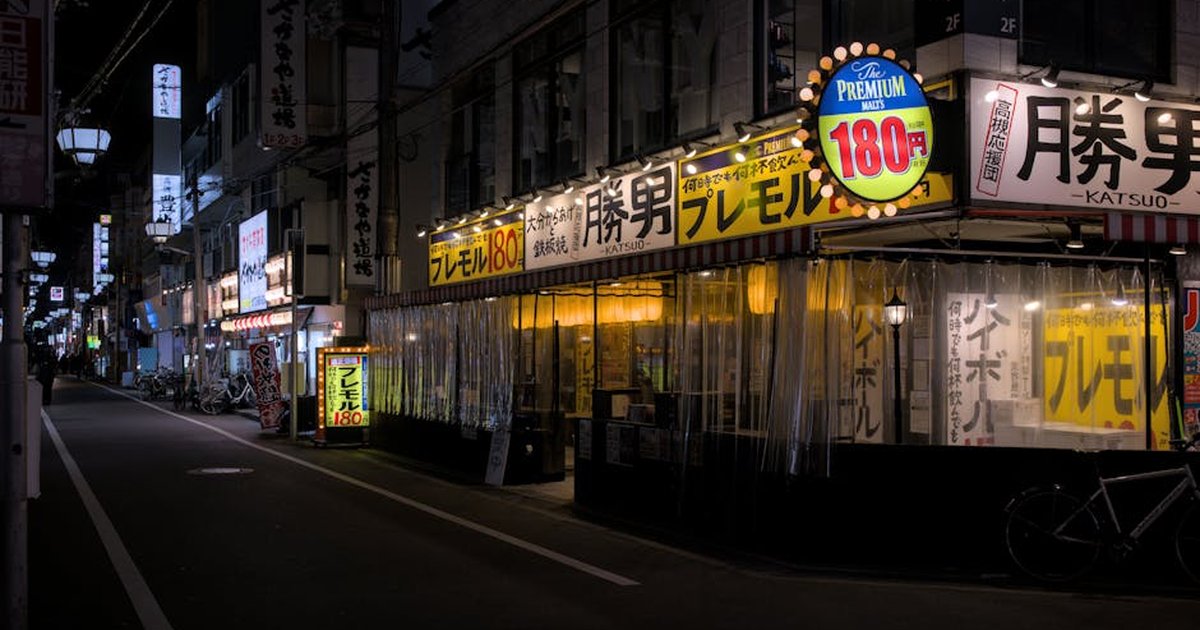Explore the quiet, illuminated streets of Takatsuki, Osaka with its iconic izakayas at night.