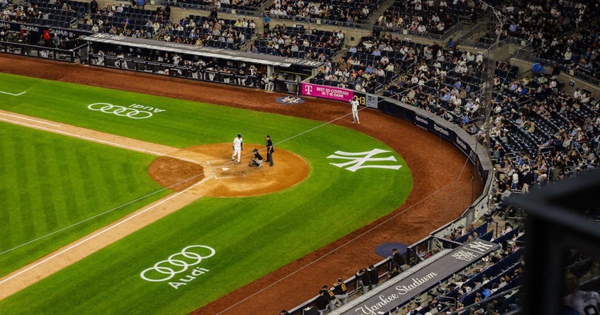 Aerial view of a baseball game at Yankee Stadium with a packed crowd.