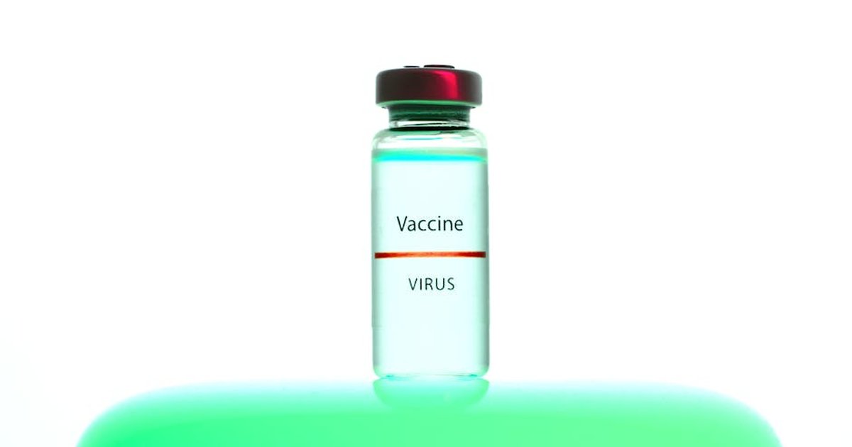 A close-up of a vaccine vial labeled 'Vaccine Virus' on a vibrant background.