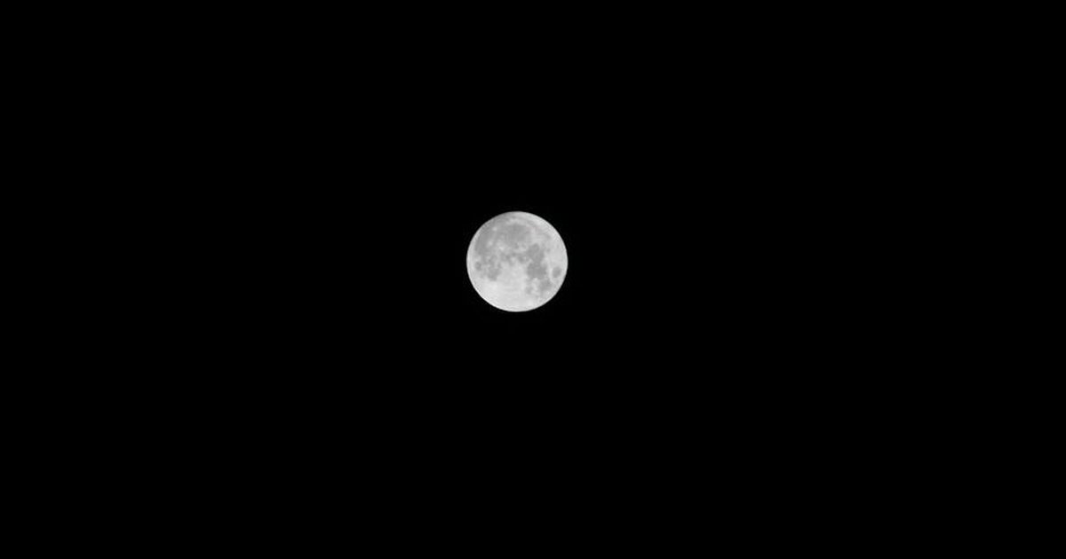 Captivating image of a full moon against a black, starless night sky.
