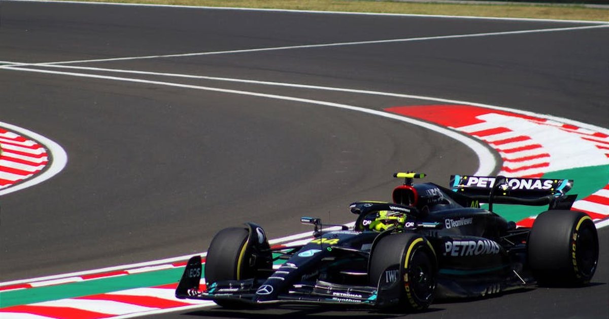 Dynamic shot of a Formula 1 car speeding around a track curve, showcasing motorsport excitement.