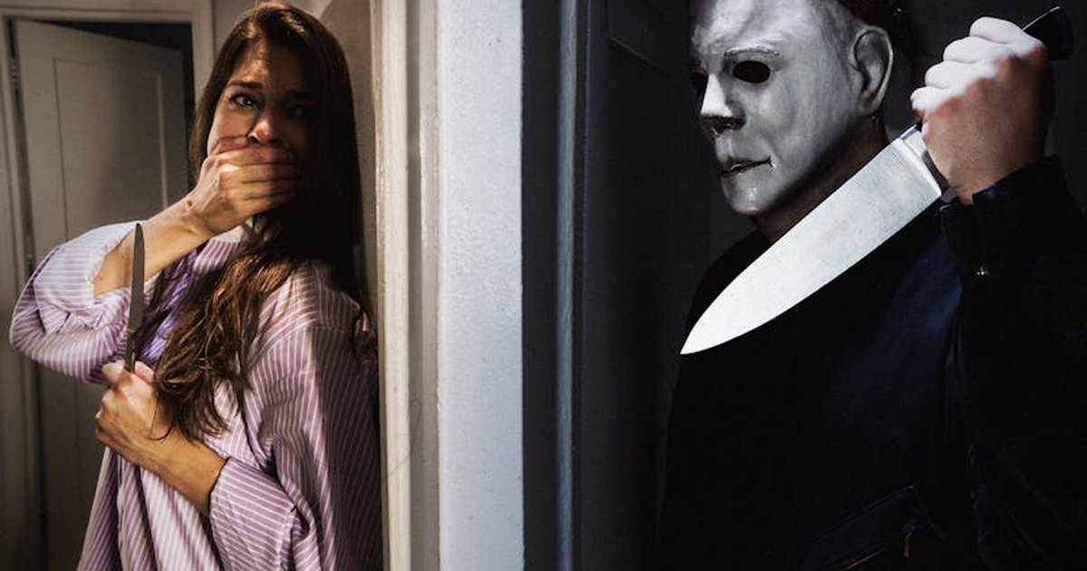 Dramatic horror scene featuring a masked figure and frightened woman indoors.